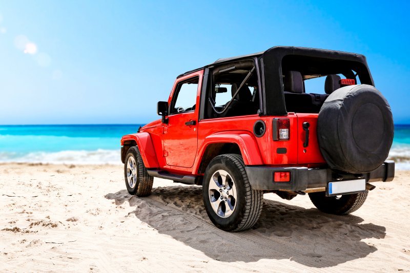 jeep parked on a sandy beach